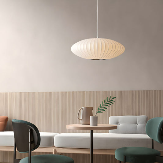 Minimalist indoor disk-shaped silk pendant lighting illuminating a modern room.