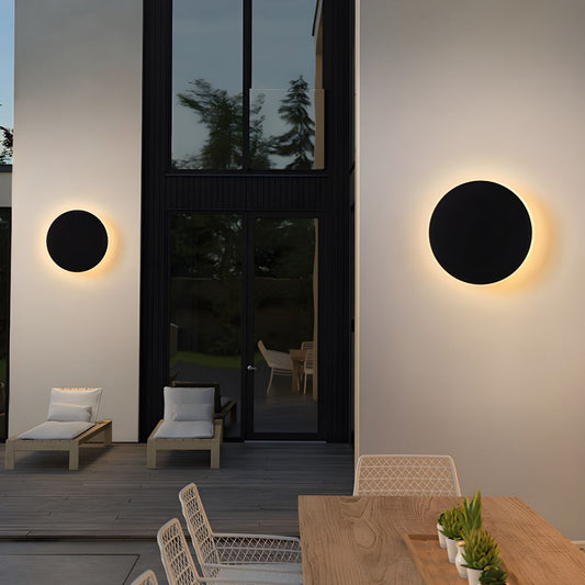 Modern style round LED outdoor wall lighting on elegant exterior.