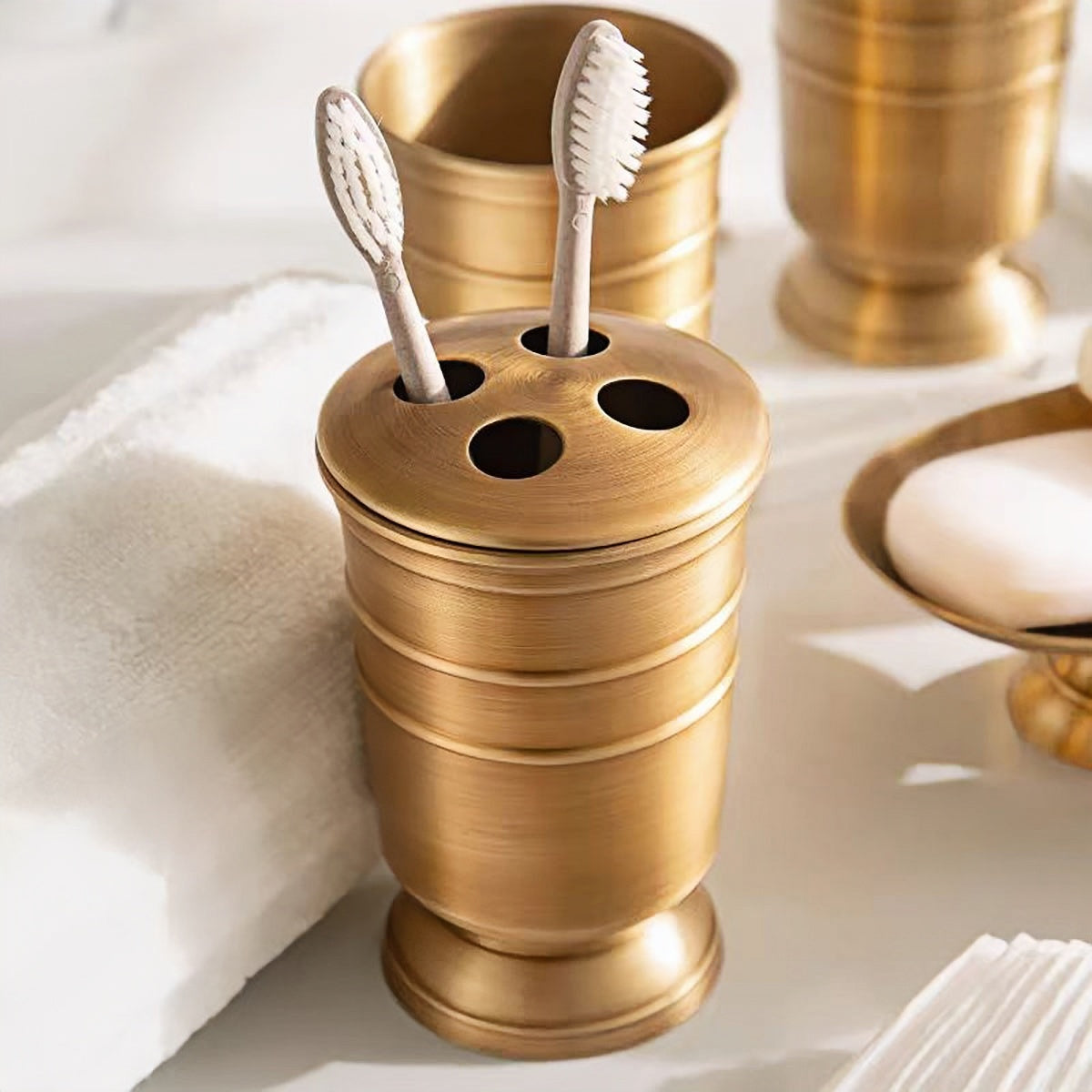 All-brass bathroom set with toothbrush holder and soap dispenser in elegant brass finish