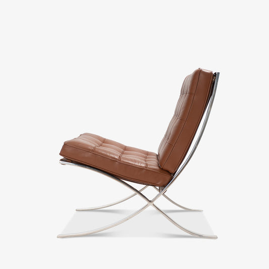 Barcelona Chair with brown leather upholstery and polished chrome frame in side view.
