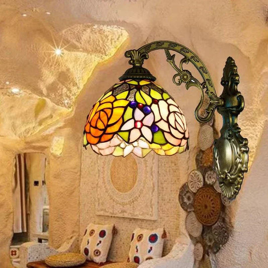 Stained Glass Wall Sconce with vibrant colors, European style, and intricate design, mounted on a rustic interior wall.