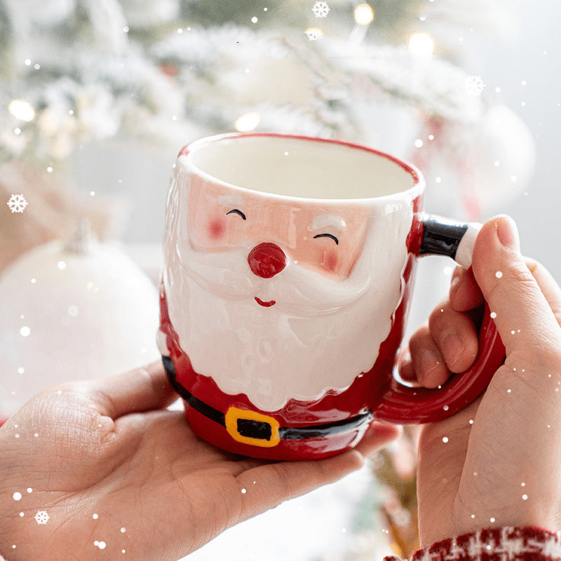Santa Claus ceramic Christmas mug with festive design held in hands.