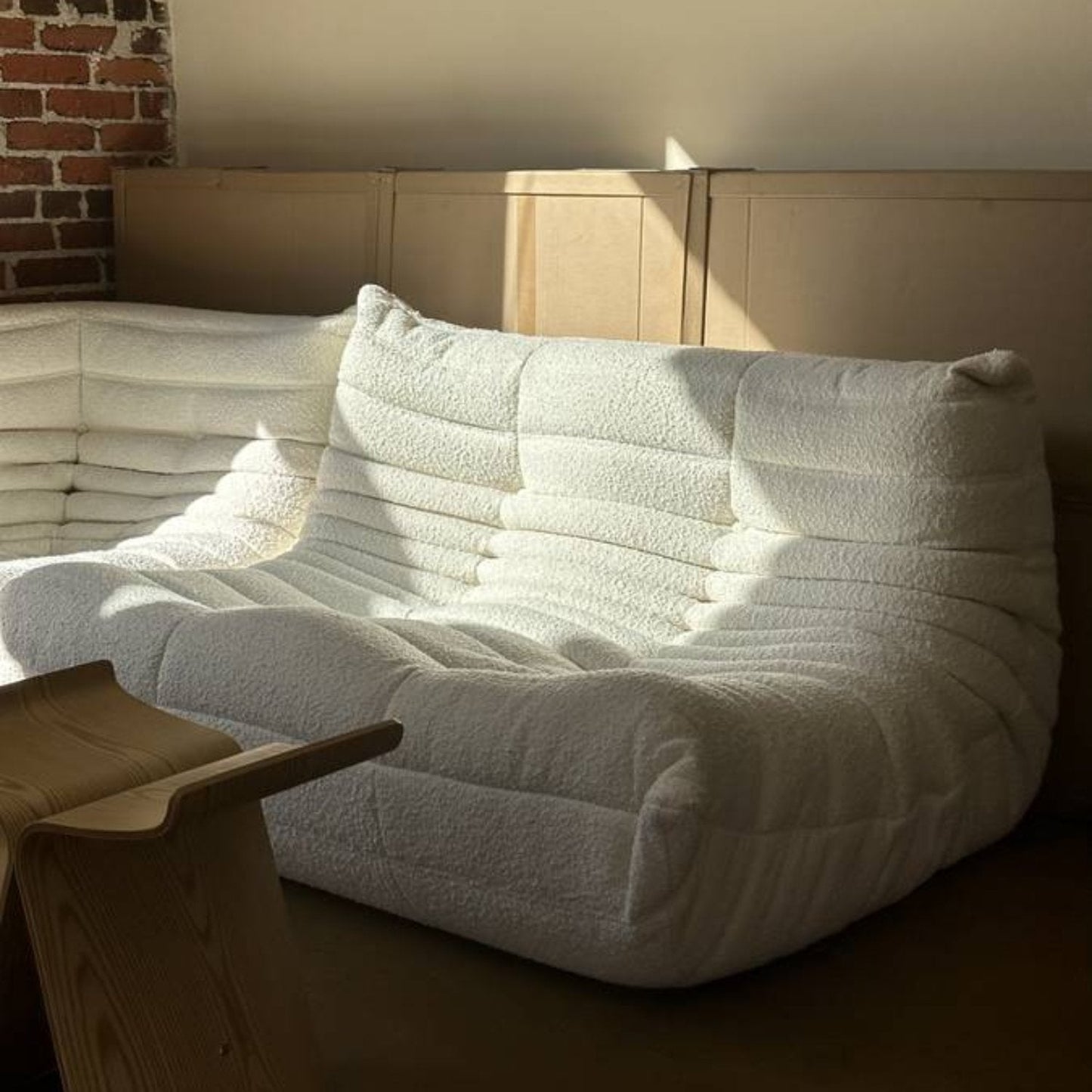 Elegant Togo loveseat sofa in plush Bouclé fabric with hand-stitched pleats and customizable colors