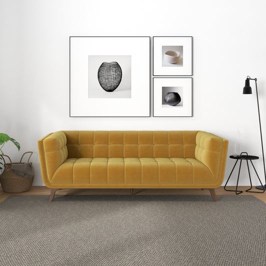 Addison large gold velvet sofa with solid wood legs and high-density foam cushions in a modern living room setting.