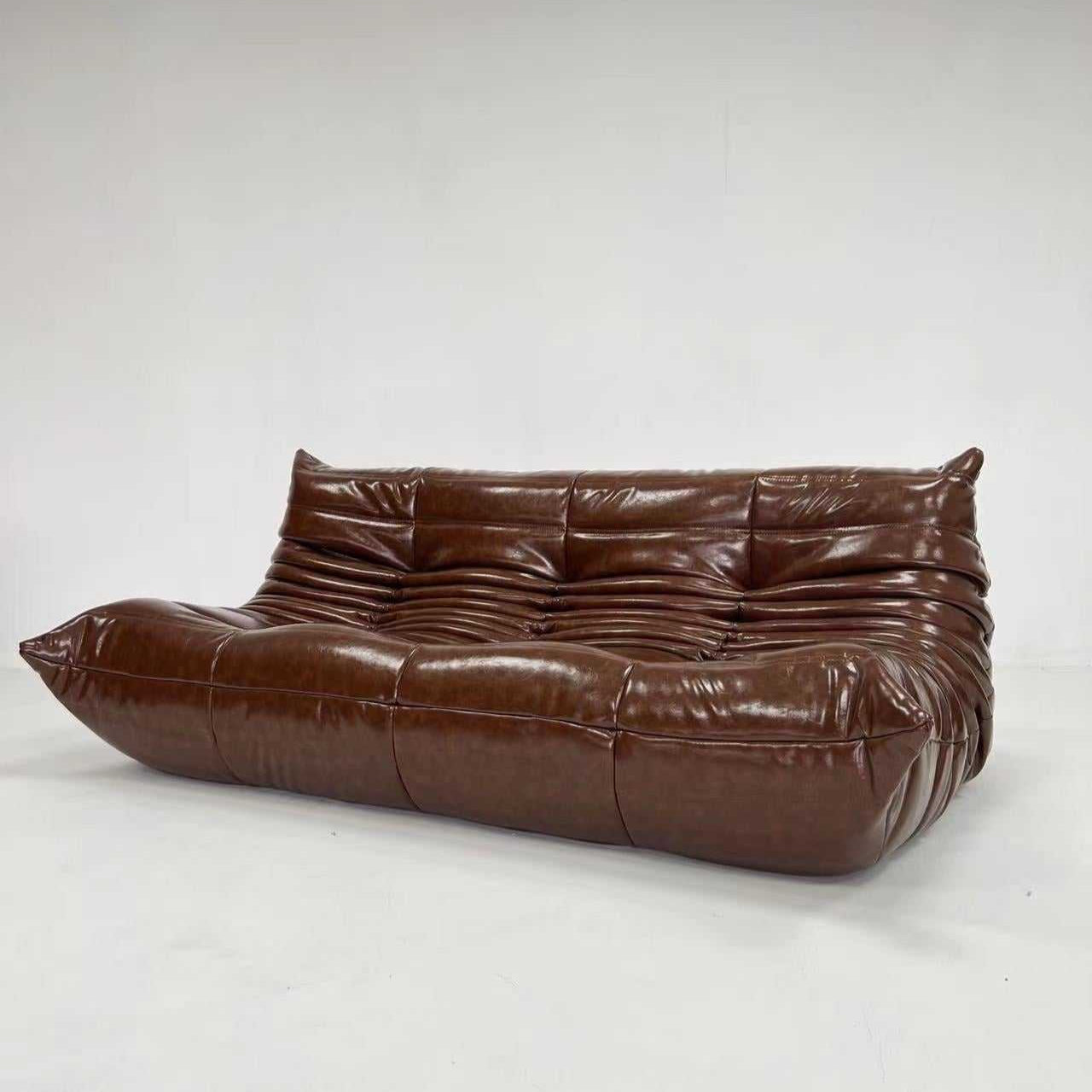 Brown Ligne Roset Togo Sofa Replica in luxurious oil wax leather with ergonomic design and plush foam cushioning.