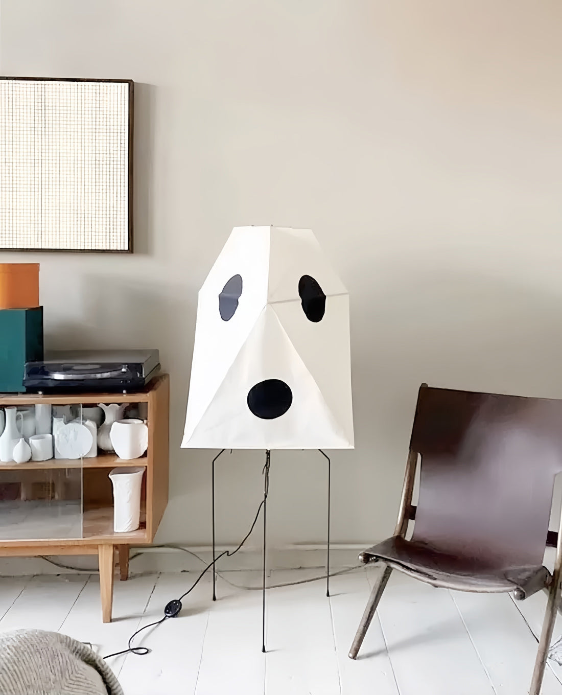 Floor Lamps For Living Rooms, a sculptural white fabric shade with bold black circular cutouts and a slim metal tripod stand.