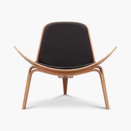 Shell 07 Chair with wing-like floating design, leather upholstery, and three-legged wood frame