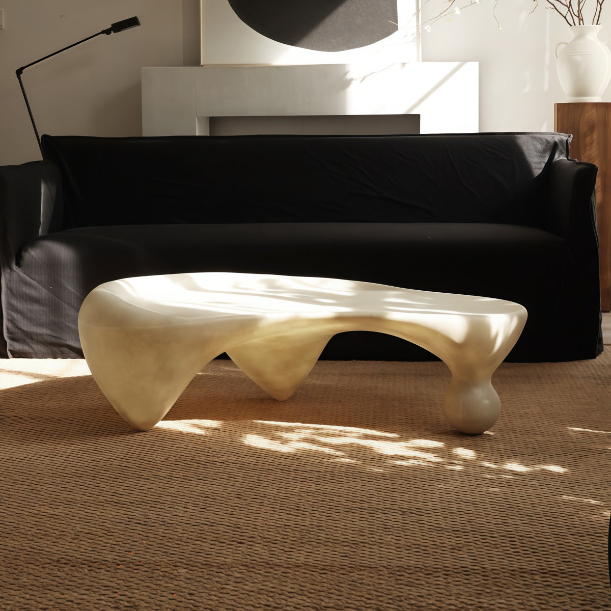 Snail-shaped coffee table in wabi-sabi style with irregular fiberglass design, available in off-white translucent and black opaque finishes