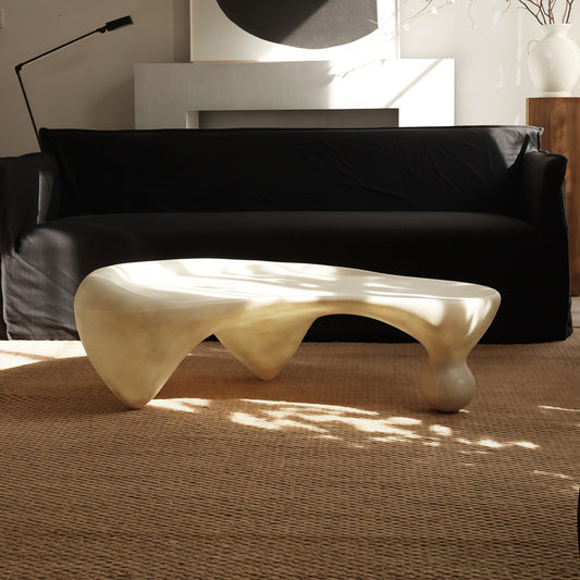 Snail-shaped coffee table in wabi-sabi style with irregular fiberglass design, available in off-white translucent and black opaque finishes