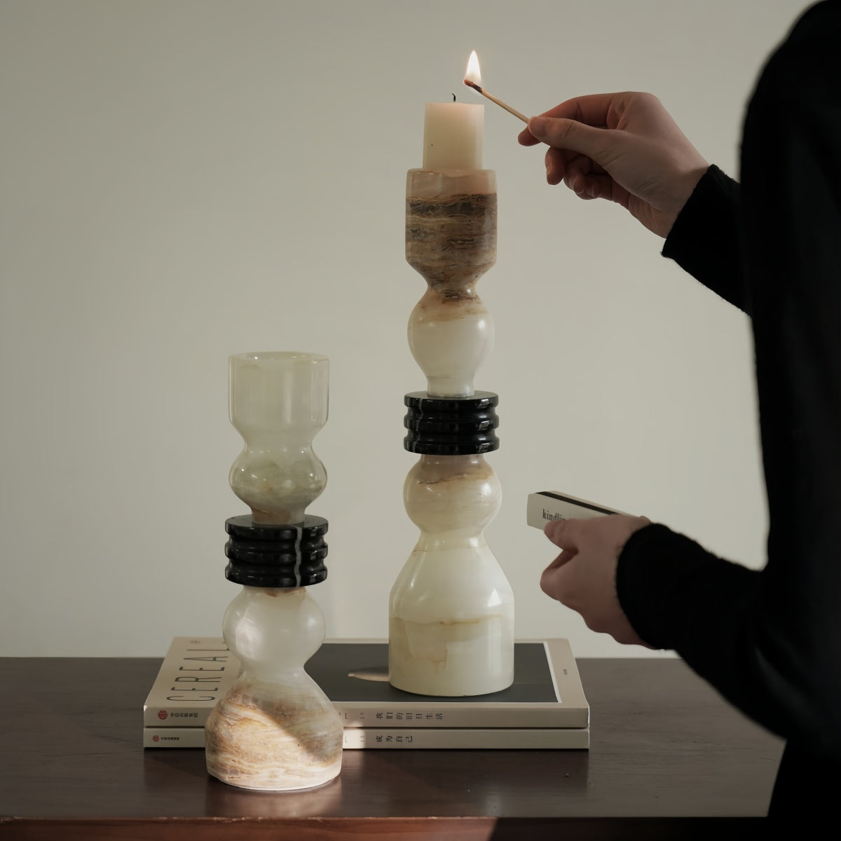Vintage candlestick made of translucent jade with layered stone body and dark ring accents for elegant living room decor