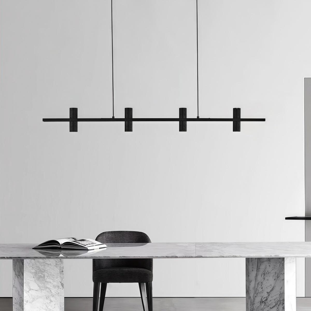 Italian Minimalist Black Travertine Pendant Light with a black linear metal bar and four cylindrical downlights.