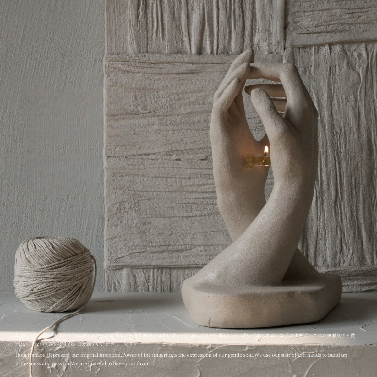 Handmade creative candlestick featuring two sculptural hands reaching out with organic curves and rustic matte texture in vintage French style