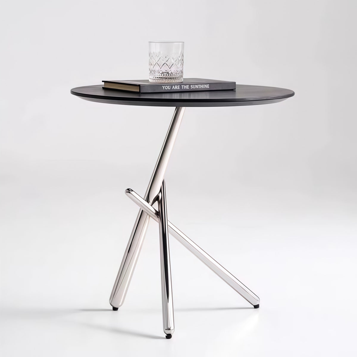 Italian minimalist sofa side table with round ash wood top and stainless steel mirror-finish base in modern living room setting