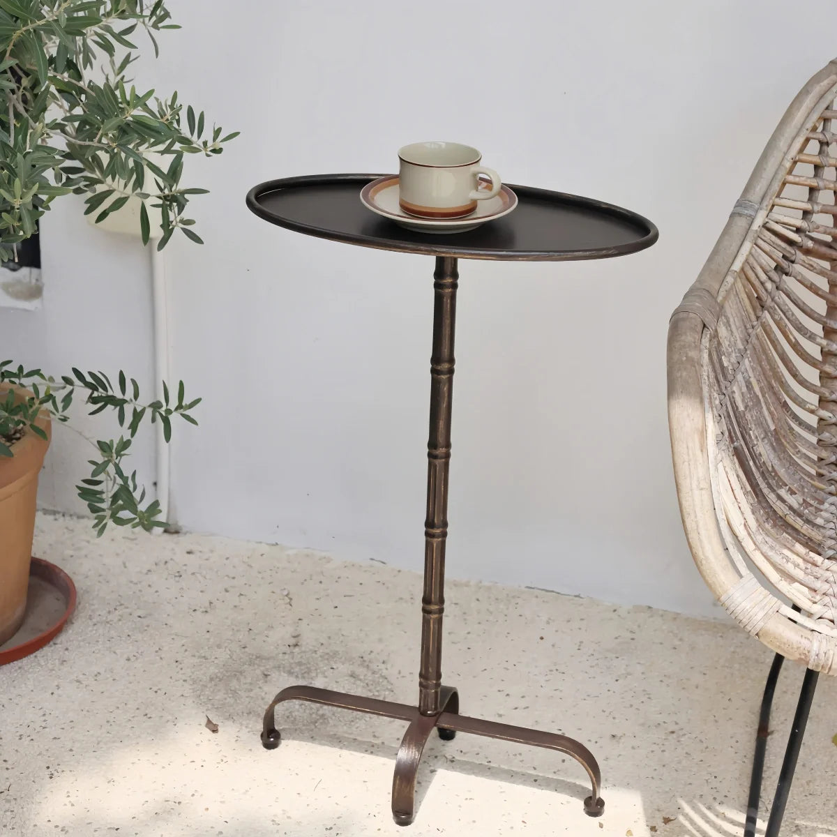 Oval Metal Side Table with dark brown metal finish, slim oval tray top, and bamboo-joint style pillar support in vintage design
