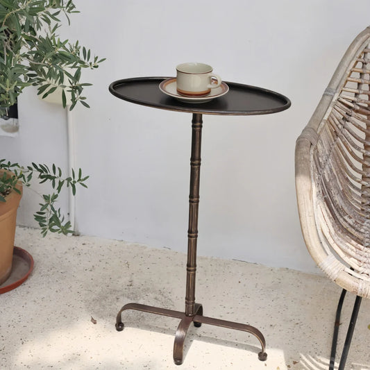 Oval Metal Side Table with dark brown metal finish, slim oval tray top, and bamboo-joint style pillar support in vintage design