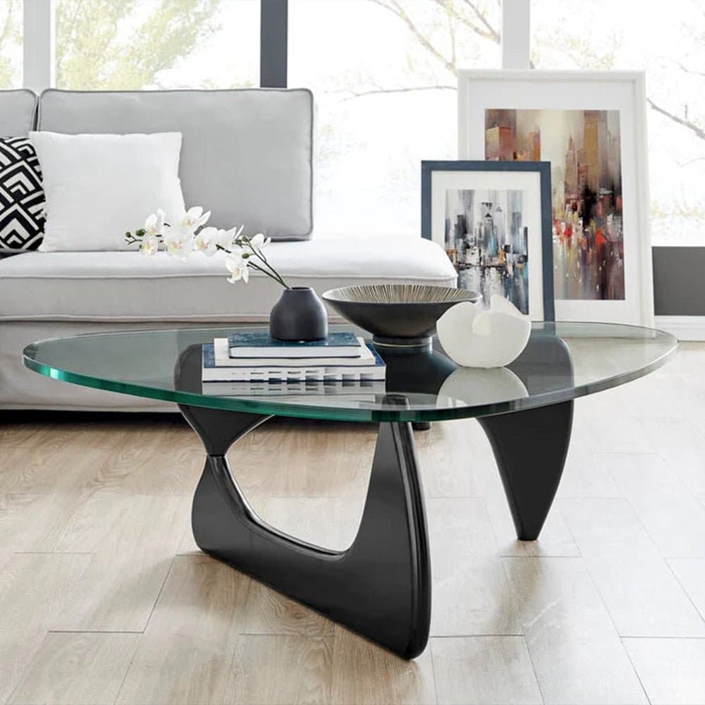 Noguchi Coffee Table with glass top and interlocking wood base in modern living room.