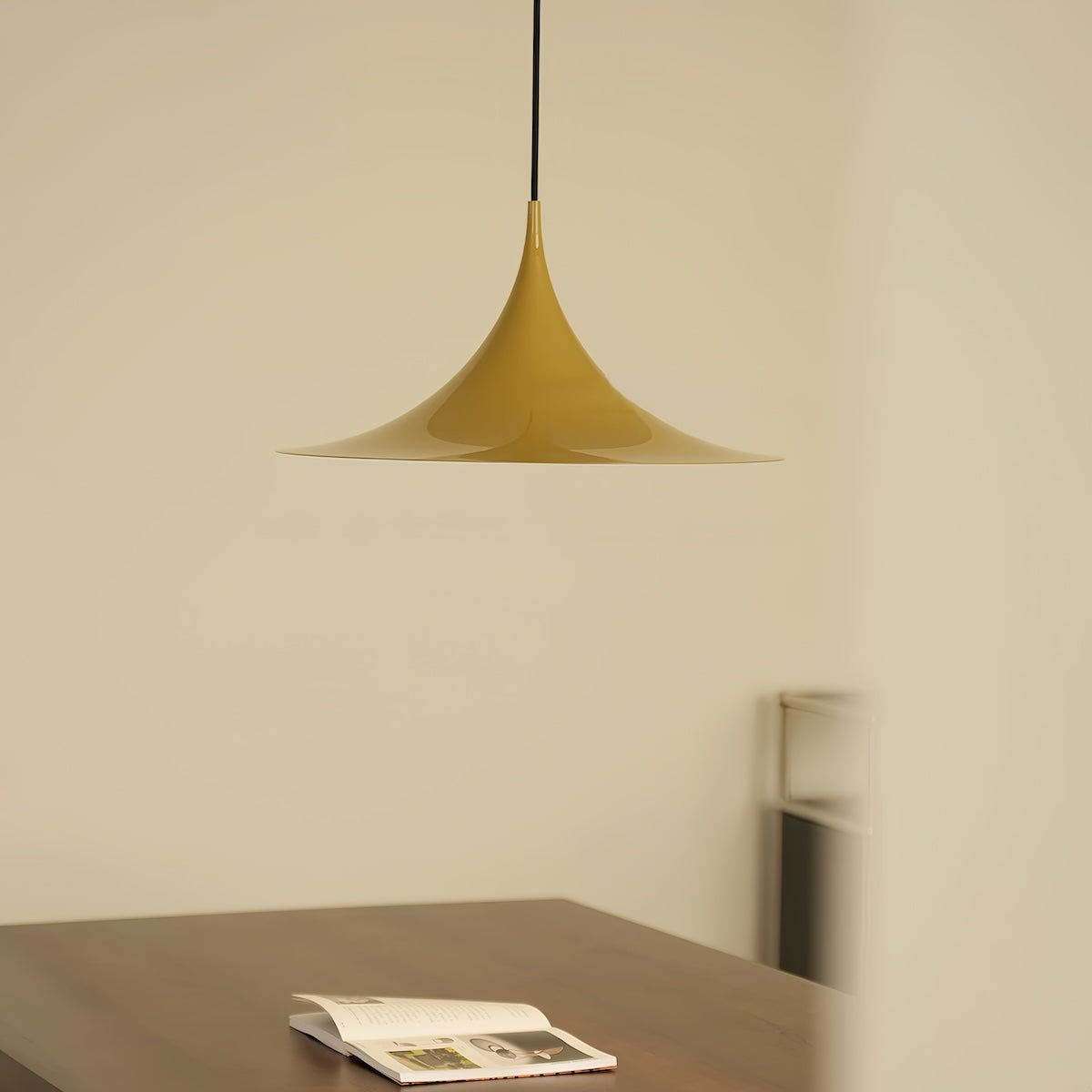 Elegant Danish UFO pendant light with glossy aluminum body illuminating contemporary dining room lighting