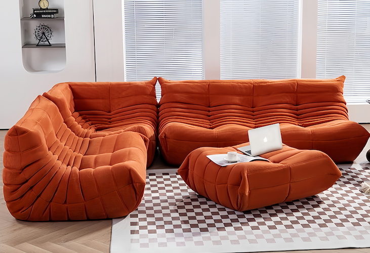 Orange Ligne Roset Togo sofa set in a modern living room.