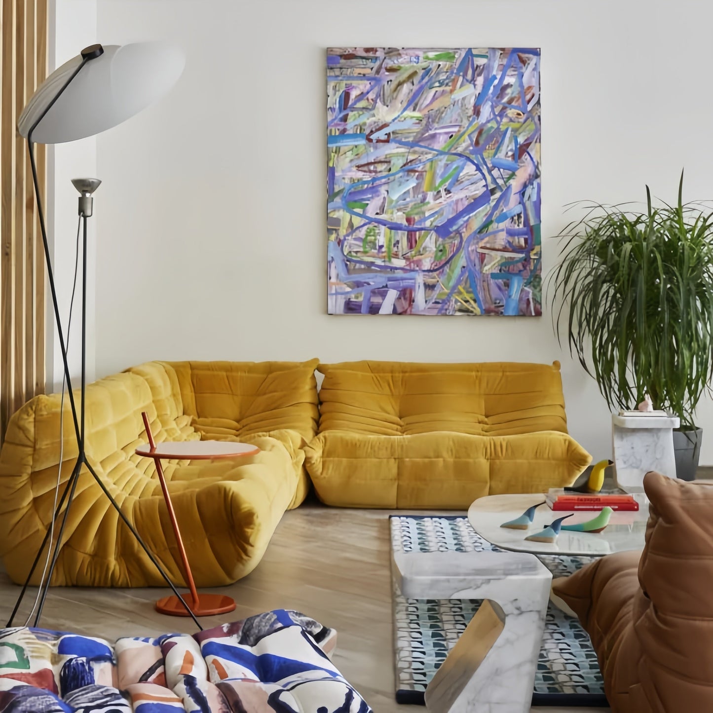 Togo 2 seater sofa in cozy yellow suede upholstery in modern living room setting