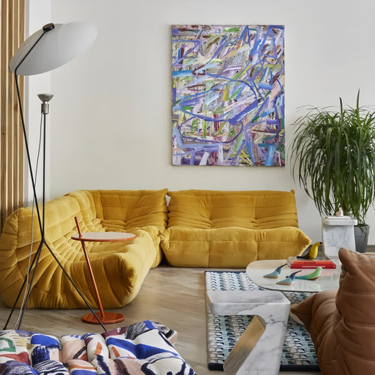Togo 2 seater sofa in cozy yellow suede upholstery in modern living room setting