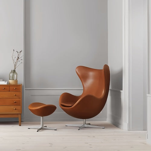 Egg Chair with stool in brown leather and sleek metal base, modern interior design - motivodecor.com