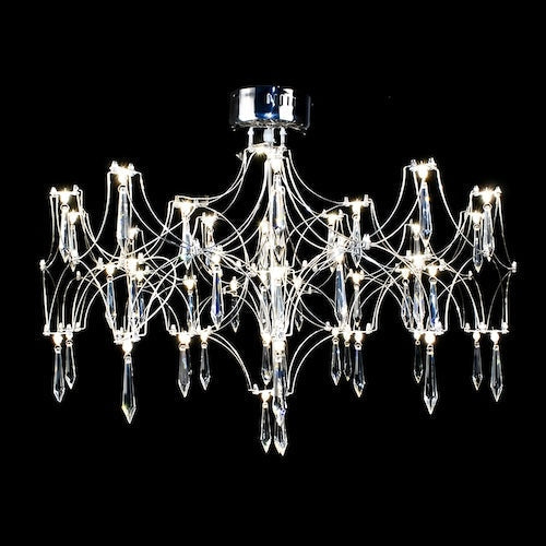 Stylish LED crystal chandelier illuminating a dining area with modern elegance - motivodecor.com