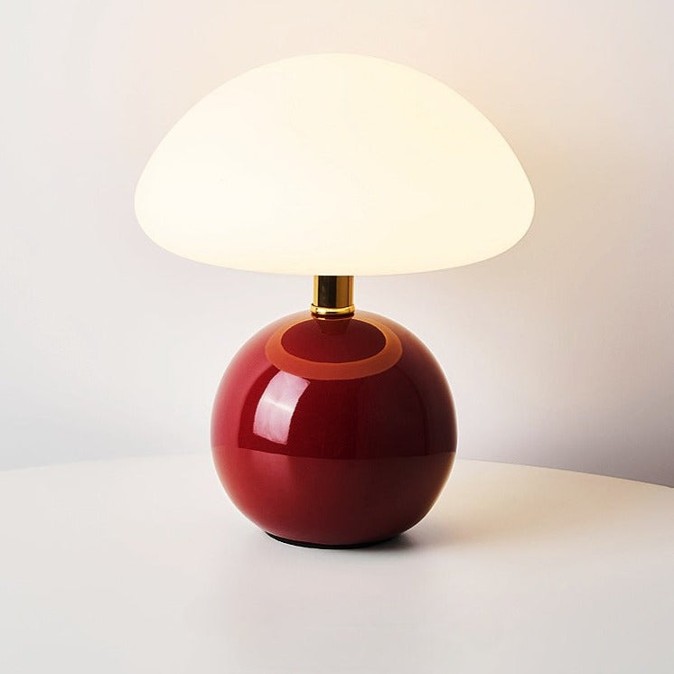 Ceramic table lamp with mushroom shape and energy-efficient LED light for cozy ambiance.