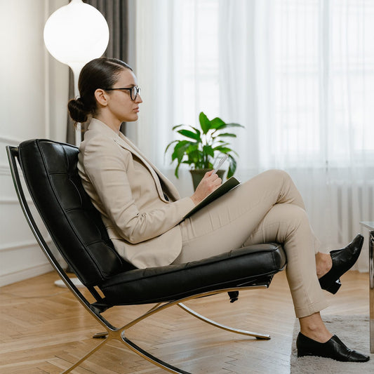 Barcelona Chair in premium black leather with sleek stainless steel frame, offering modern luxury and timeless design.