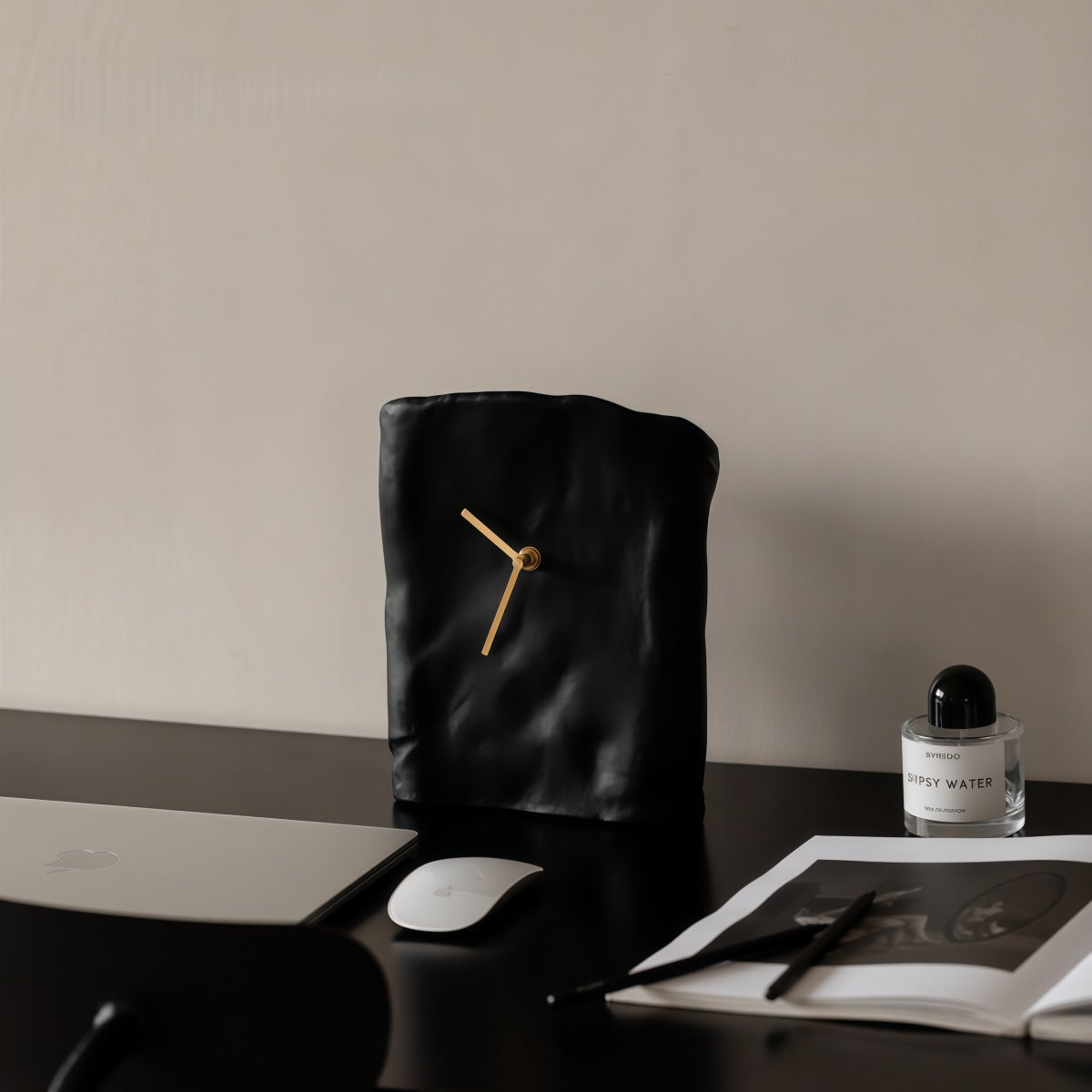 Black resin desk clock on a desk