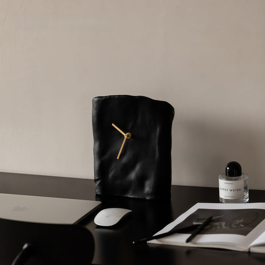 Black resin desk clock on a desk