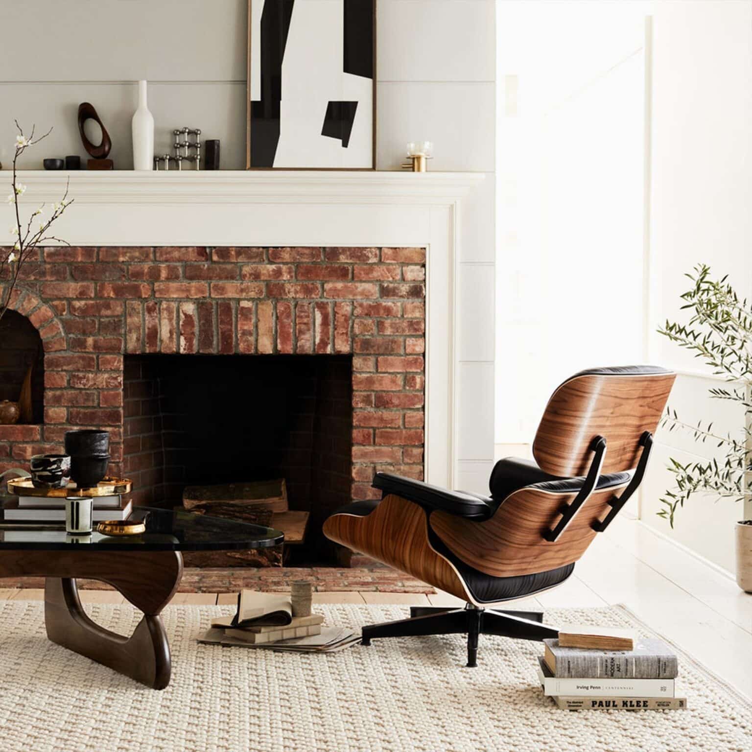 Eames Lounge Chair replica in a stylish interior setting with brick fireplace.