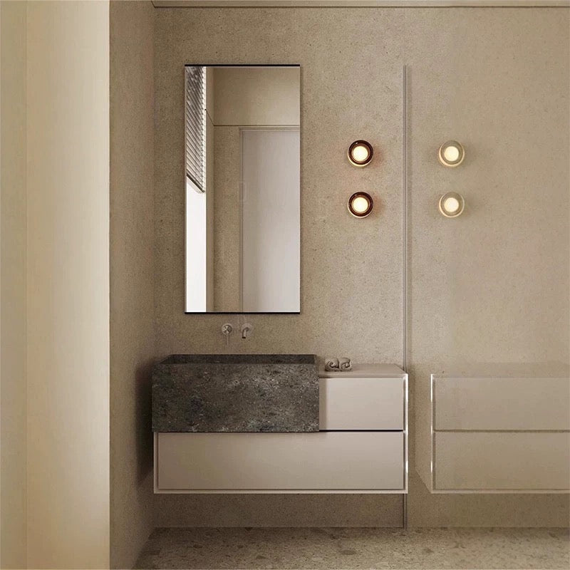 Modern bathroom with stylish wall sconce lighting.