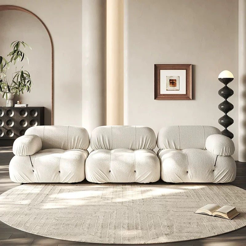 Modular sofa sectional with flexible fabric modules in a modern living room setting.