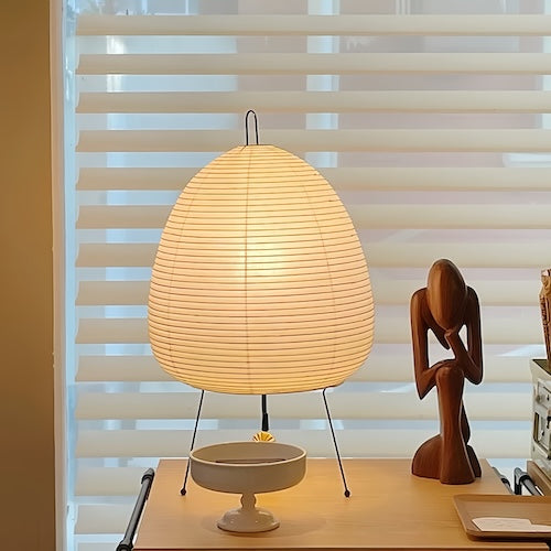 Traditional Japanese rice paper lamp on a wooden table, showcasing Wabi-sabi style design with warm light.