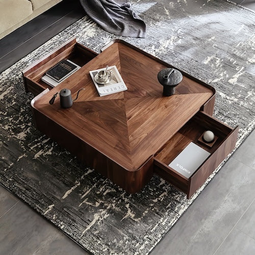 Walnut coffee table with storage drawers and concave tabletop on patterned rug.