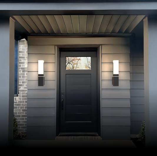 Modern exterior wall light fixtures with sleek black aluminum design illuminating a front door entrance at dusk