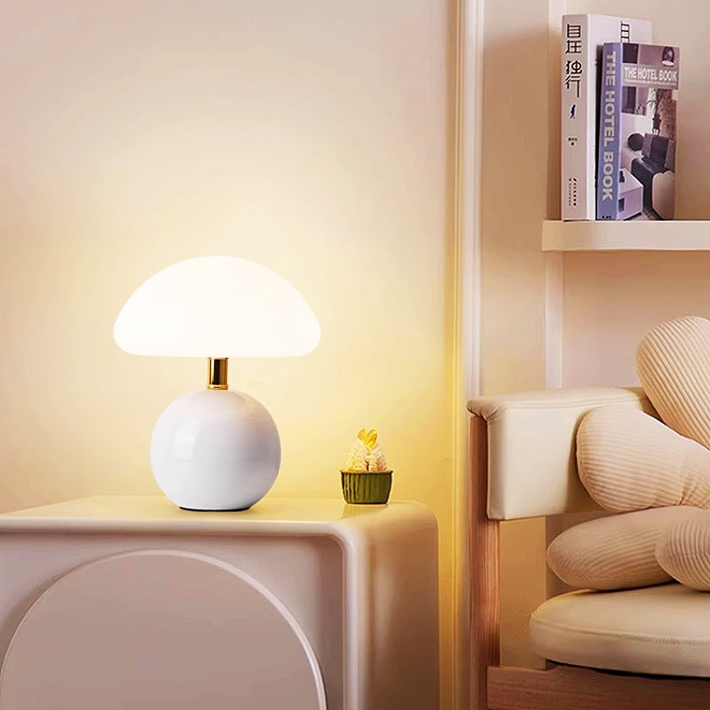 Ceramic table lamp with mushroom shape, creating cozy ambiance on a side table.