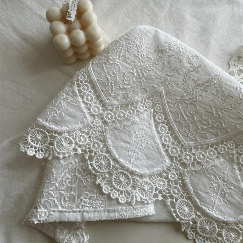 Handmade white tablecloth with intricate embroidery, 100% cotton, elegant rectangular design.