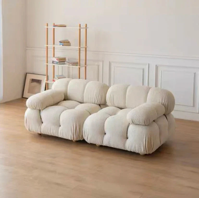 Modular sofa sectional with flexible fabric modules in white living room setting.