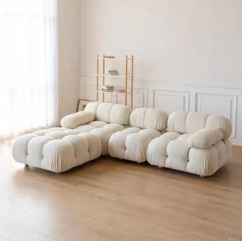 Modular sofa sectional with flexible fabric modules in a modern living room setting.