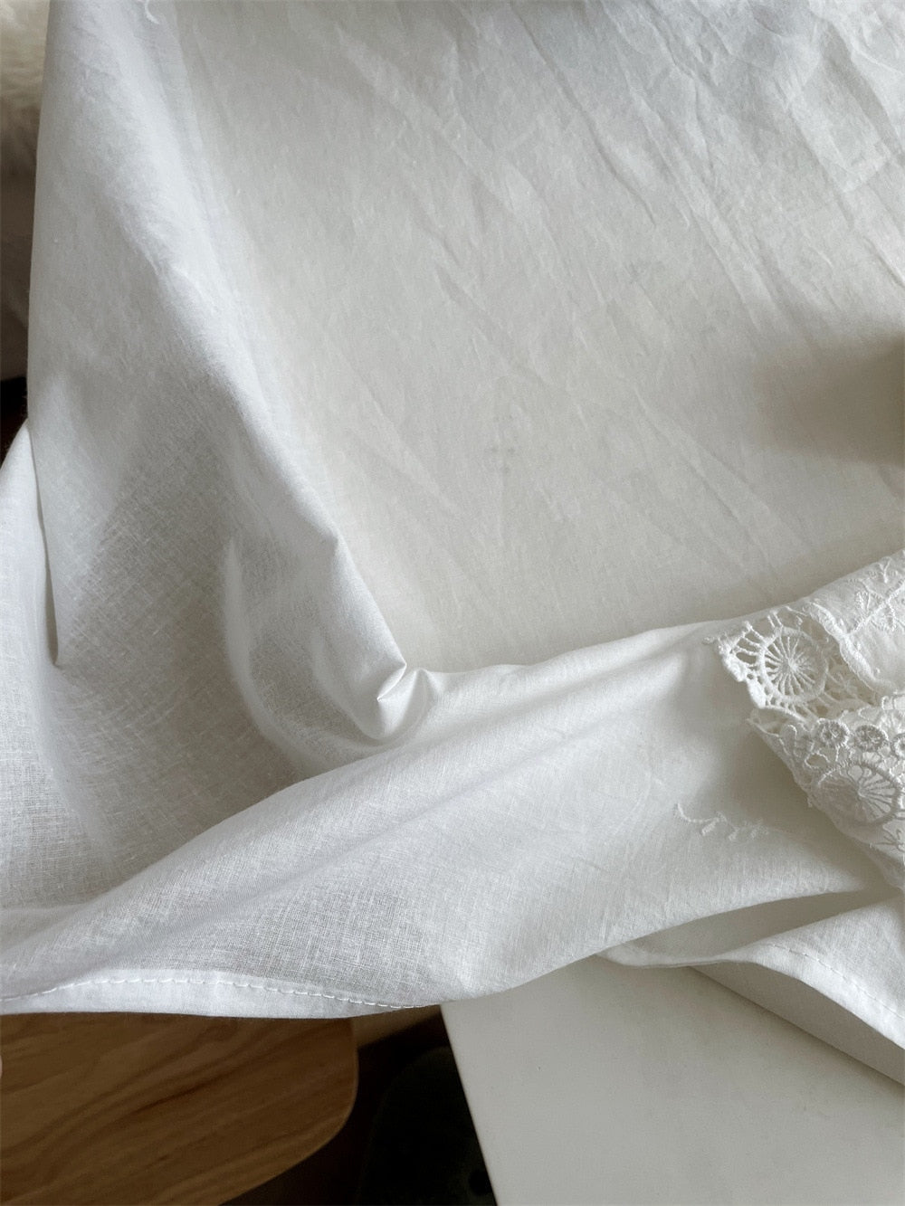 Handmade white tablecloth with intricate embroidery, 100% cotton, elegant and durable for any occasion.