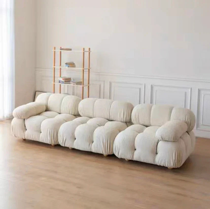 Modular sofa sectional with flexible fabric modules in a modern living room setup.