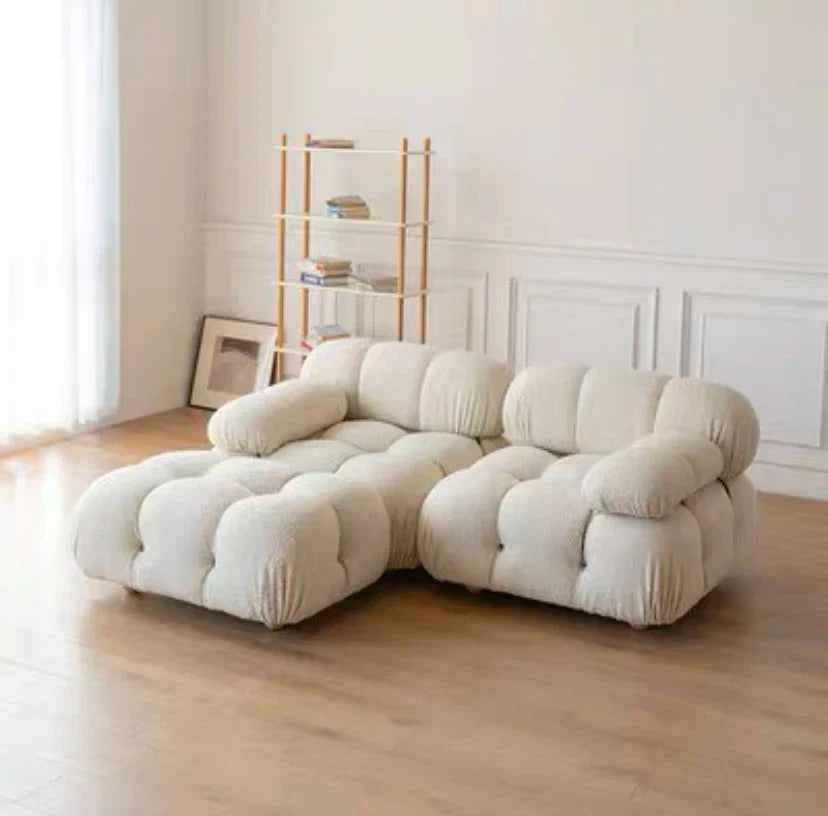 Modular sofa sectional in flexible fabric modules for customizable living room setup.