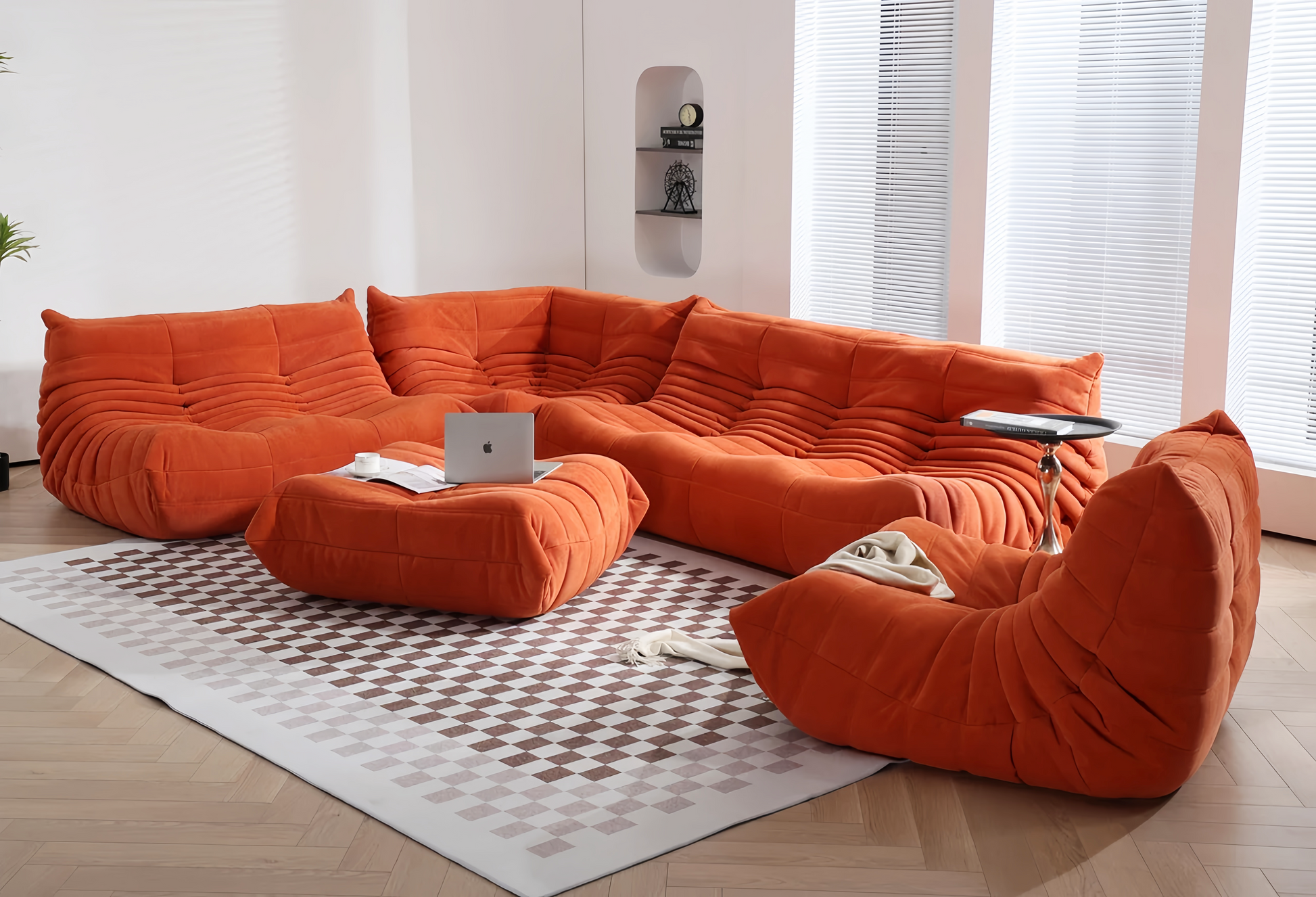 Ligne Roset Togo sofa set in orange, plush curved cushions, modern living room.