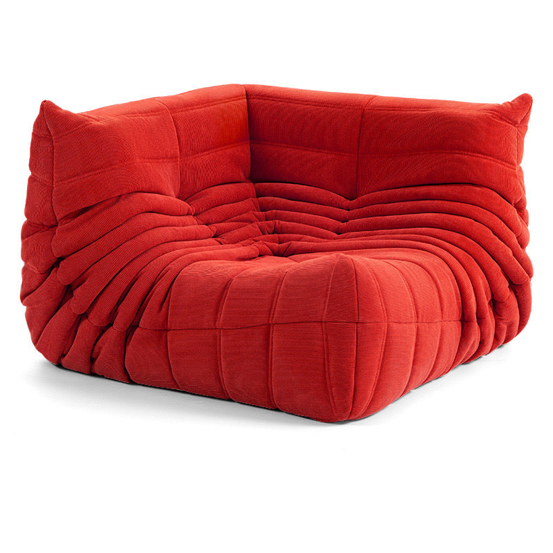 Red corduroy corner sofa with modular design for customizable living space.