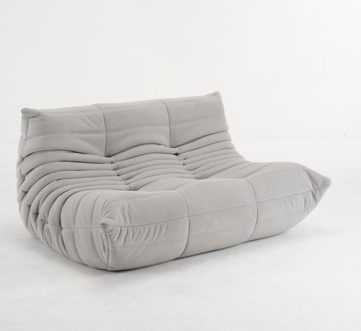 Togo 2 Seater Sofa in beige corduroy with ergonomic foam design in modern living room