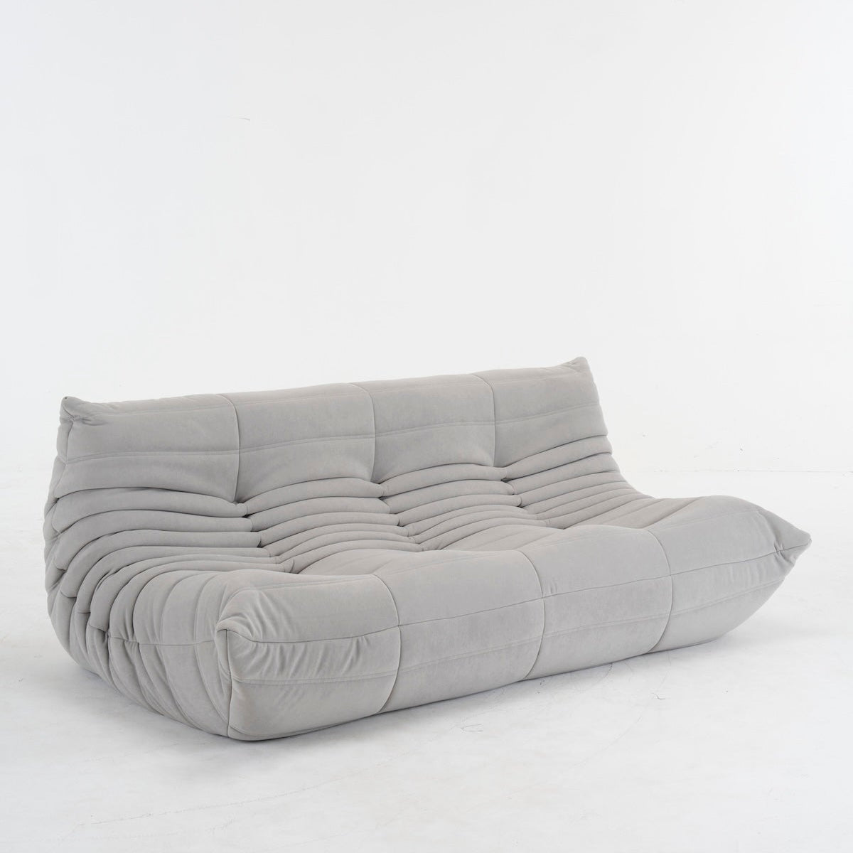 Togo Couch in vibrant red, black, brown, orange, and pink corduroy upholstery