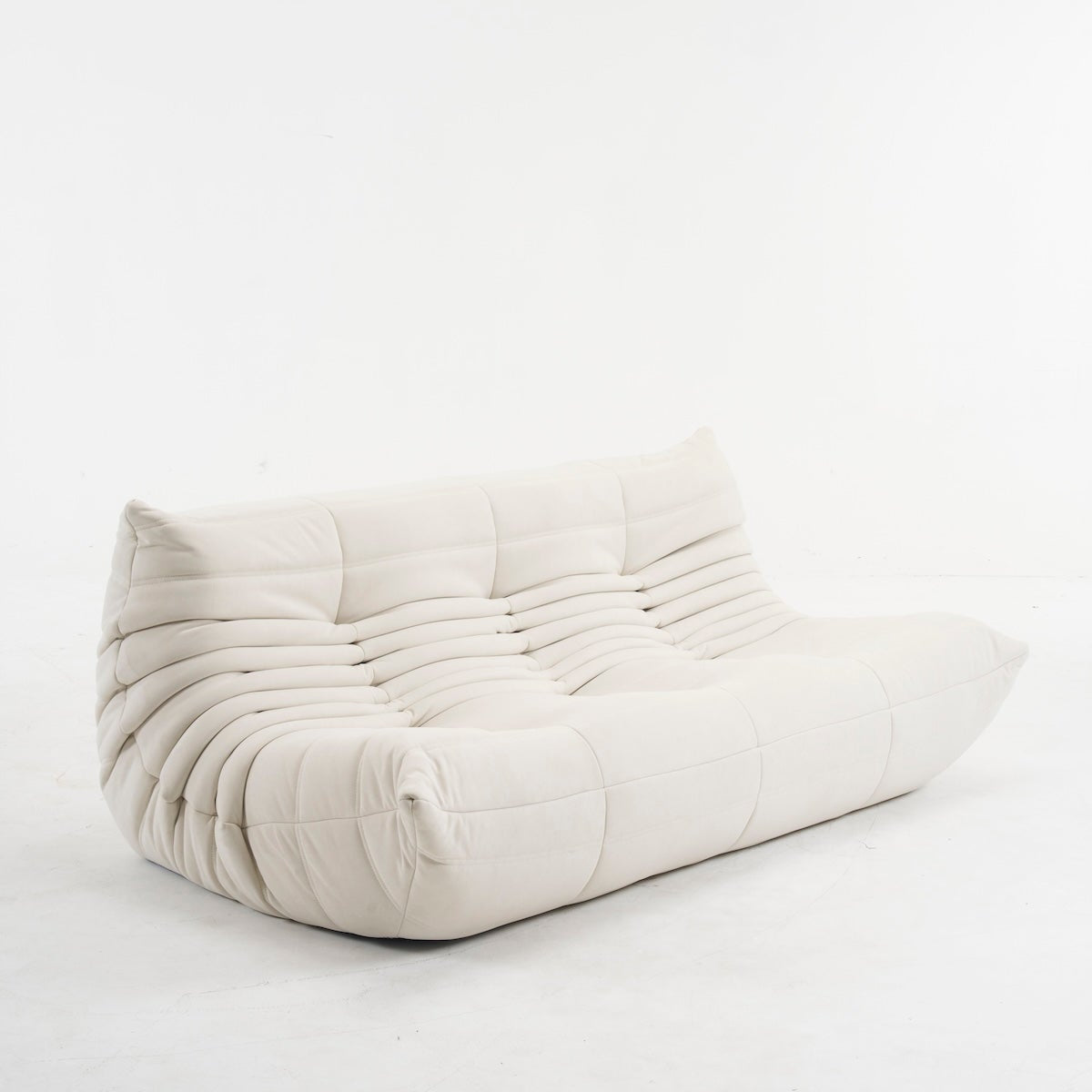 White pleated cushion on a light gray background