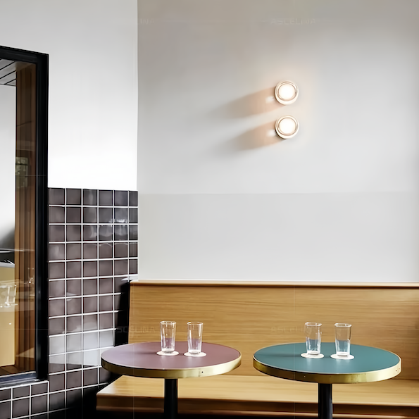 Wall sconce lighting with warm light in a stylish cafe setting.