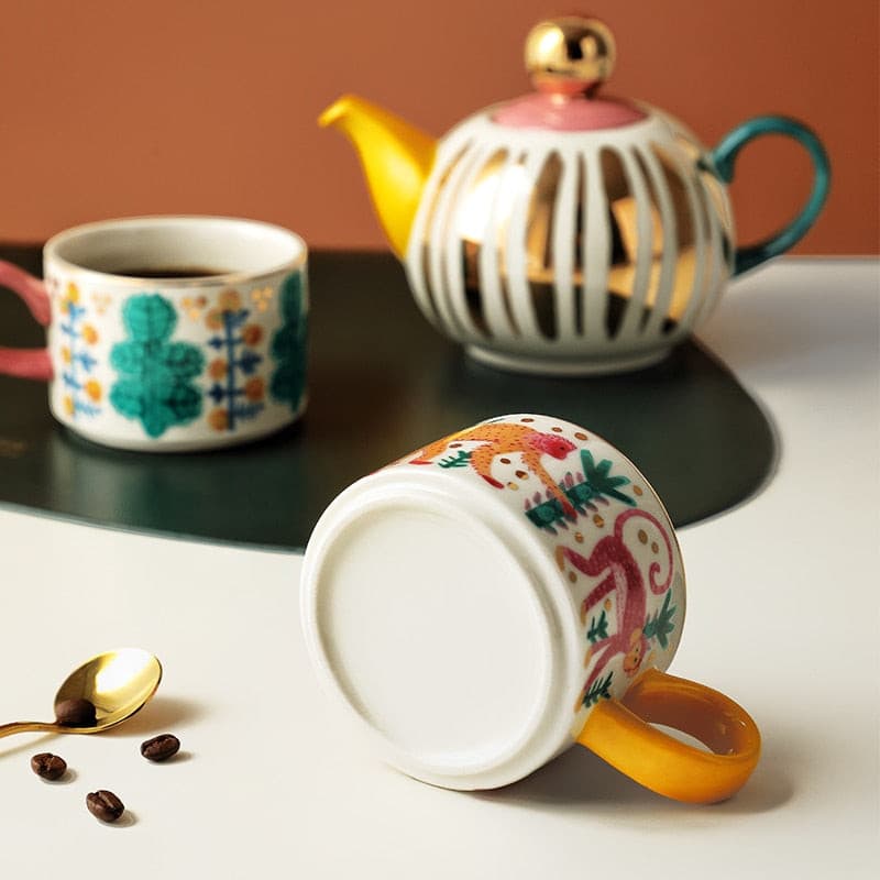 Afternoon tea aesthetic cute ceramic tea set with colorful designs, including teapot and cups.